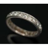 An early 20th century diamond eternity ring, twenty four round transitional cut diamonds weighing