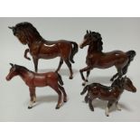 Four Beswick horses including two foals.