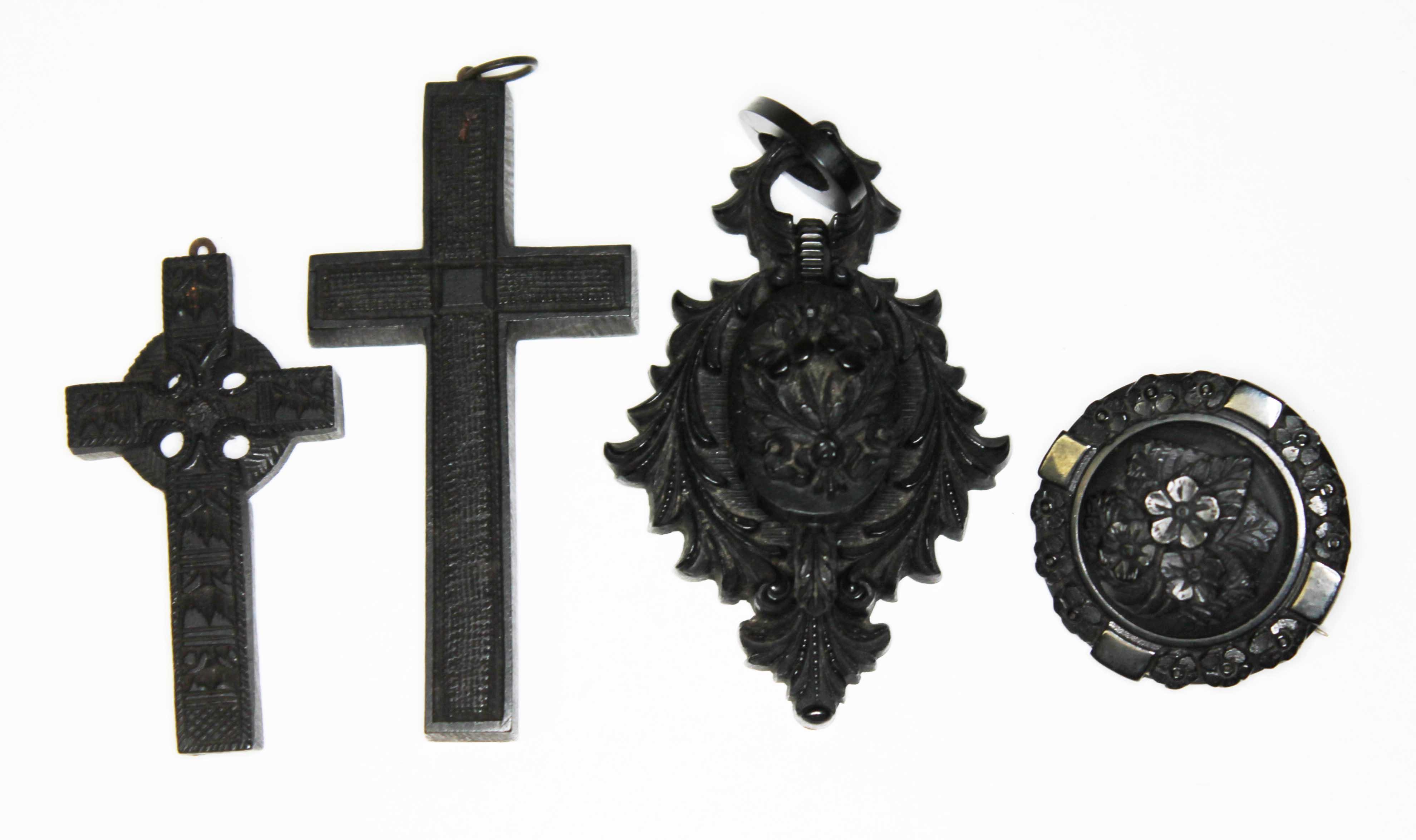 Victorian jet jewellery comprising a Celtic cross , another cross, a pendant locket and a brooch.