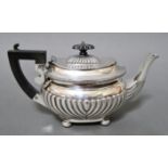 A silver tea pot with bakelite finial and handle, on bun feet, hallmarked for 1902, Birmingham,