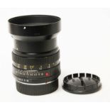 A Leitz Summilux-R 1:1.4/50 lens with hood.