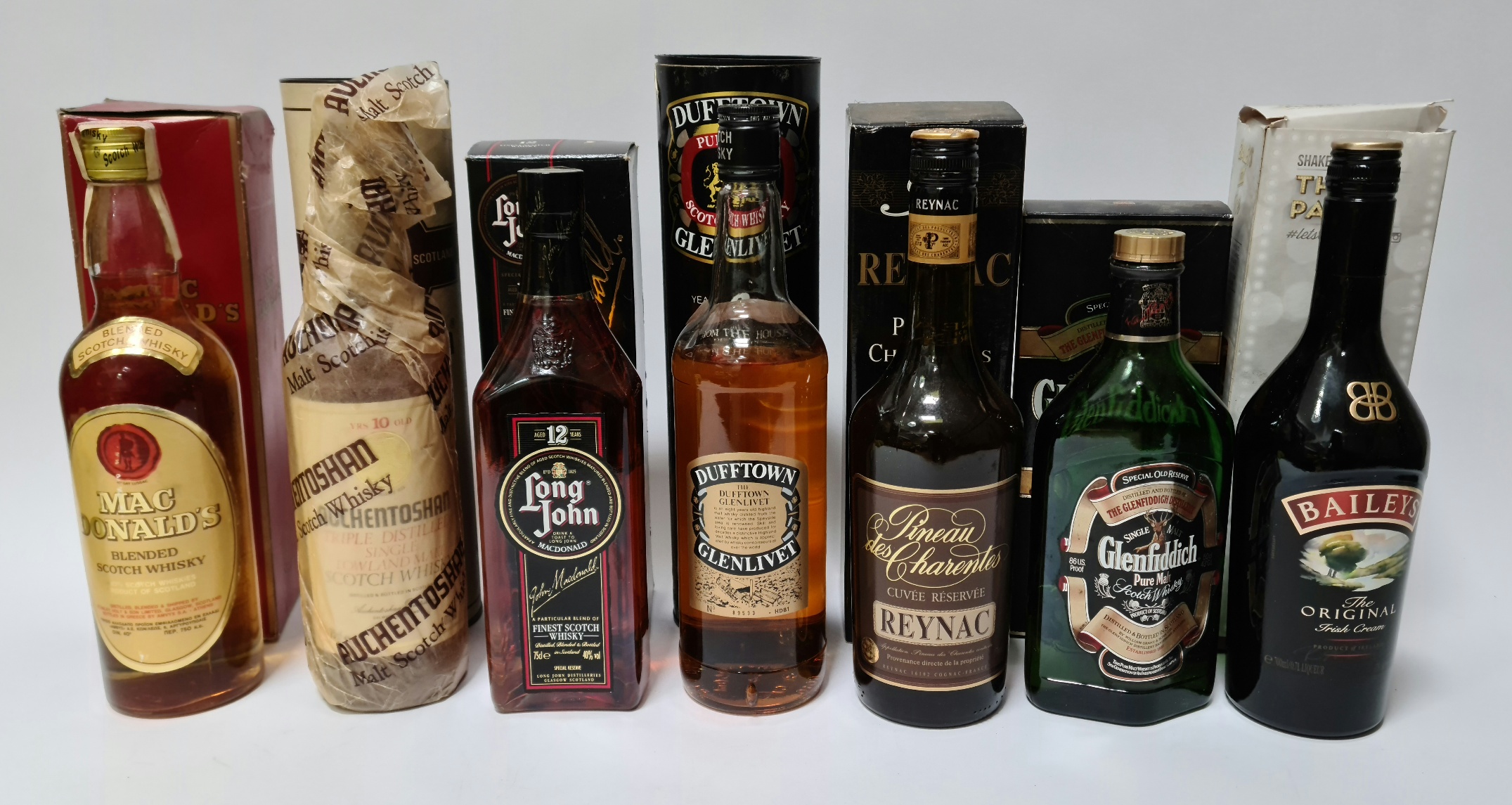 A selection of alcoholic beverages to include Reynac Pineau des Charentes, a Mac Donald's blended