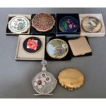 A box of assorted vintage compacts.