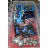 A box of various die-cast and composite model cars, mainly related to Subaru.