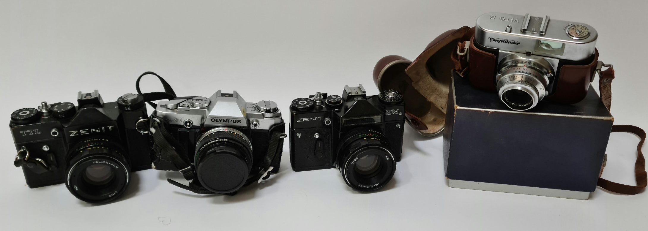 A vintage Zenit EM camera, a Zenit TTL camera, a Olympus OM30 camera and a Voigtlander Vito B