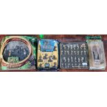 Three Lord of the rings figure sets and a gold & silver metal chessmen set.