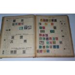 An old Schaubek's illustrated postage stamp album with collection of various stamps