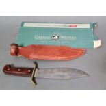 An American Coleman Western Bowie knife with leather scabbard and outer box, circa 1980s.