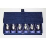 A cased set of six glass shot glasses, eash with applied Argentinian silver plaque.