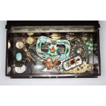 An old bakelite box containing various pieces of jewellery and watches, etc to include a silver