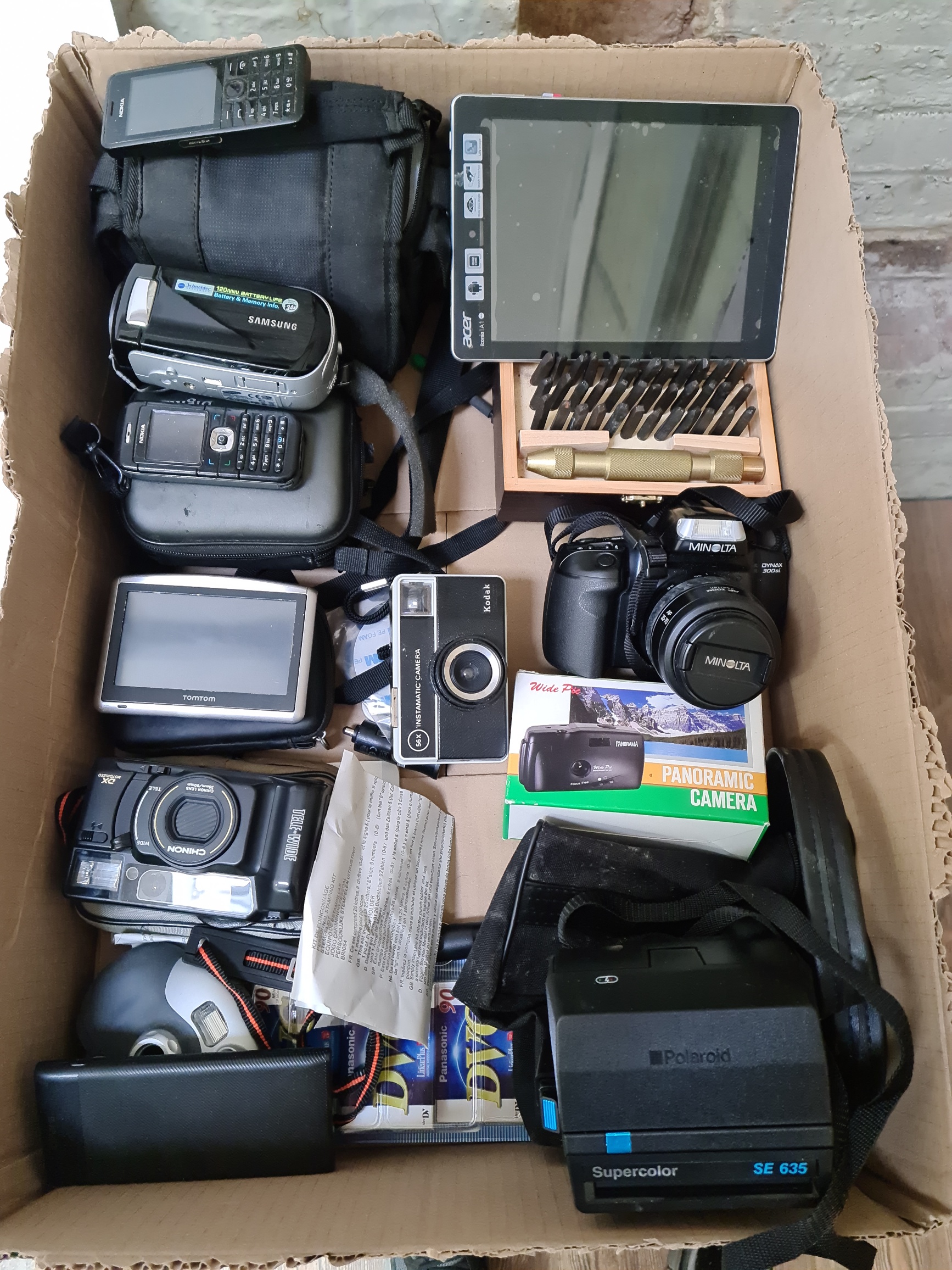 A box of miscellaneous cameras, telephones and navigators to include Minolta Dynax 300si, Polaroid