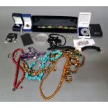 A box of costume jewellery including assorted beaded necklaces, a Swarovksi ring etc.