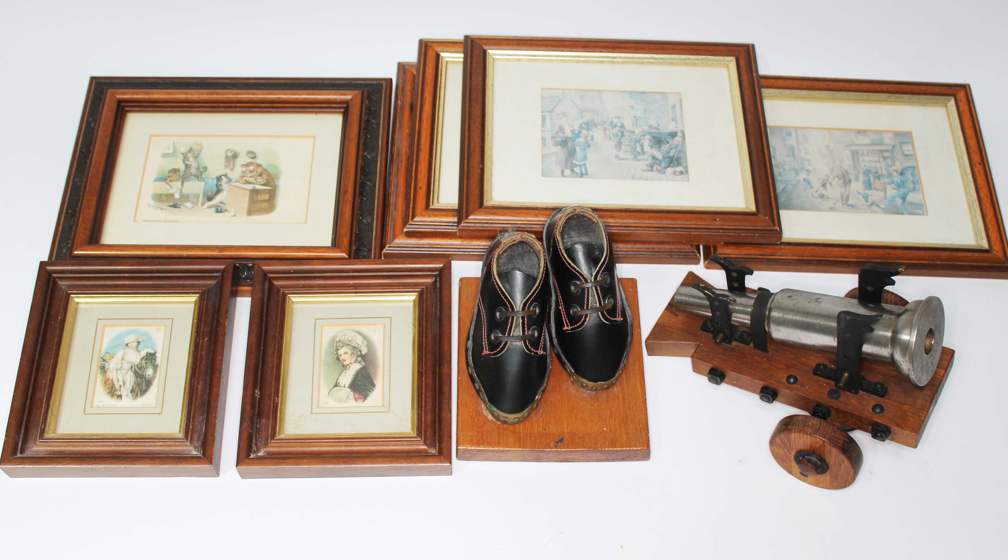 A mini cannon on stand, vintage Lancashire clogs on stand and a selection of pictures to include two