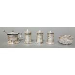 A silver cruet set including 3 lidded pots with cobalt blue glass liner, vinegar jar and cut glass
