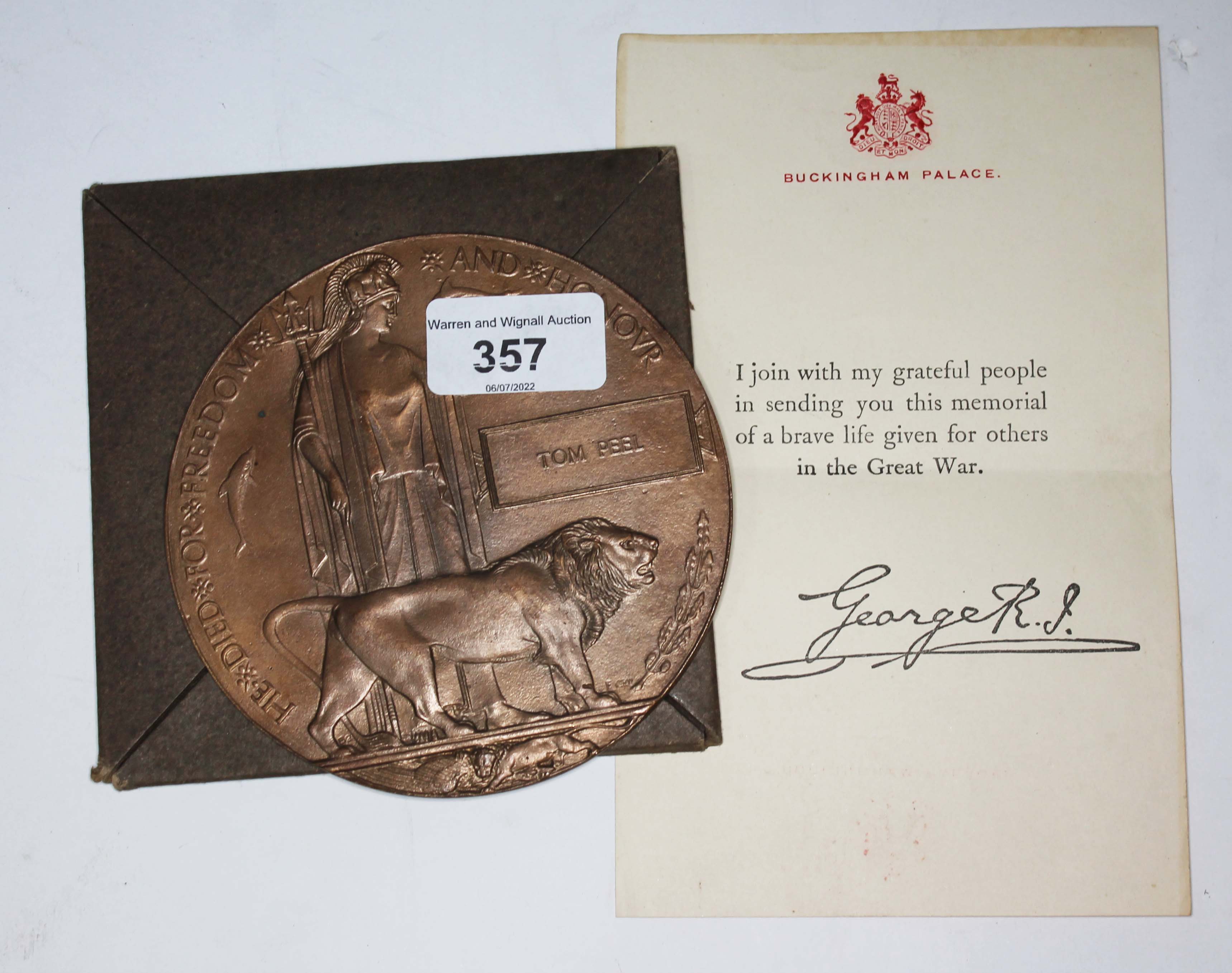 A WWI bronze death plaque for Tom Peel, with letter and cardboard envelope.