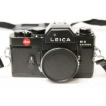 A Leica R3 Electronic 35mm SLR black camera body, serial no. 1457471, with strap.