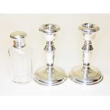 Hallmarked silver comprising a pair of candlesticks and a scent bottle with silver top heights