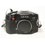 A Leica R9 SLR camera body, black, serial no. 2926066, with strap.