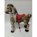 A circa 1940s - 1950s tin plate Mobo pony.