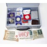 A tin of assorted coins including one 1977 silver crown, bank notes etc.