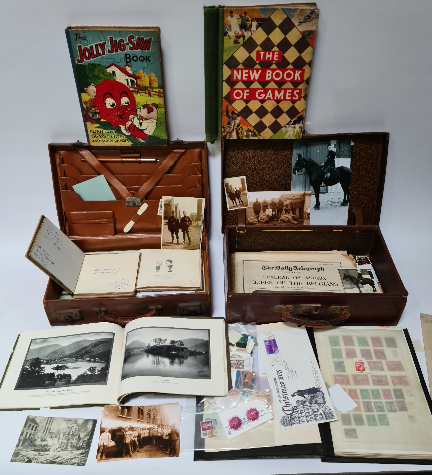 Two vintage cases containing various militaria, pictures, stamps and vintage autograph booklets