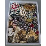 Assorted costume jewellery including a Swarovski Venetian mask brooch etc.