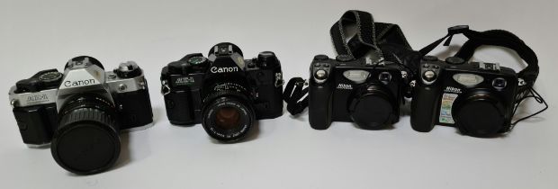 A selection of cameras to include two Canon AE-1 Program cameras and two Nikon Coolpix 5400 cameras,