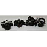 A selection of cameras to include two Canon AE-1 Program cameras and two Nikon Coolpix 5400 cameras,