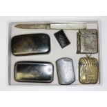 A mixed lot comprising four snuff boxes, a hallmarked silver vesta case and another, a hallmarked