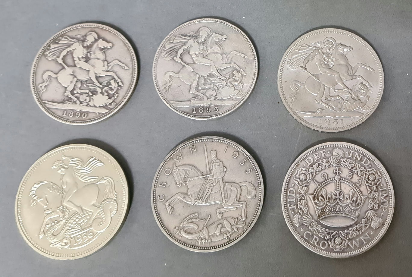 Six British crown coins including 1890, 1893, 1932, 1935, 1936, and 1951