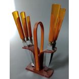 An Art Deco butterscotch bakelite knife set, the steel blades marked 'Rostfrei Solingen'.