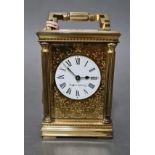 A Mappin & Webb gilt brass carriage clock with key.