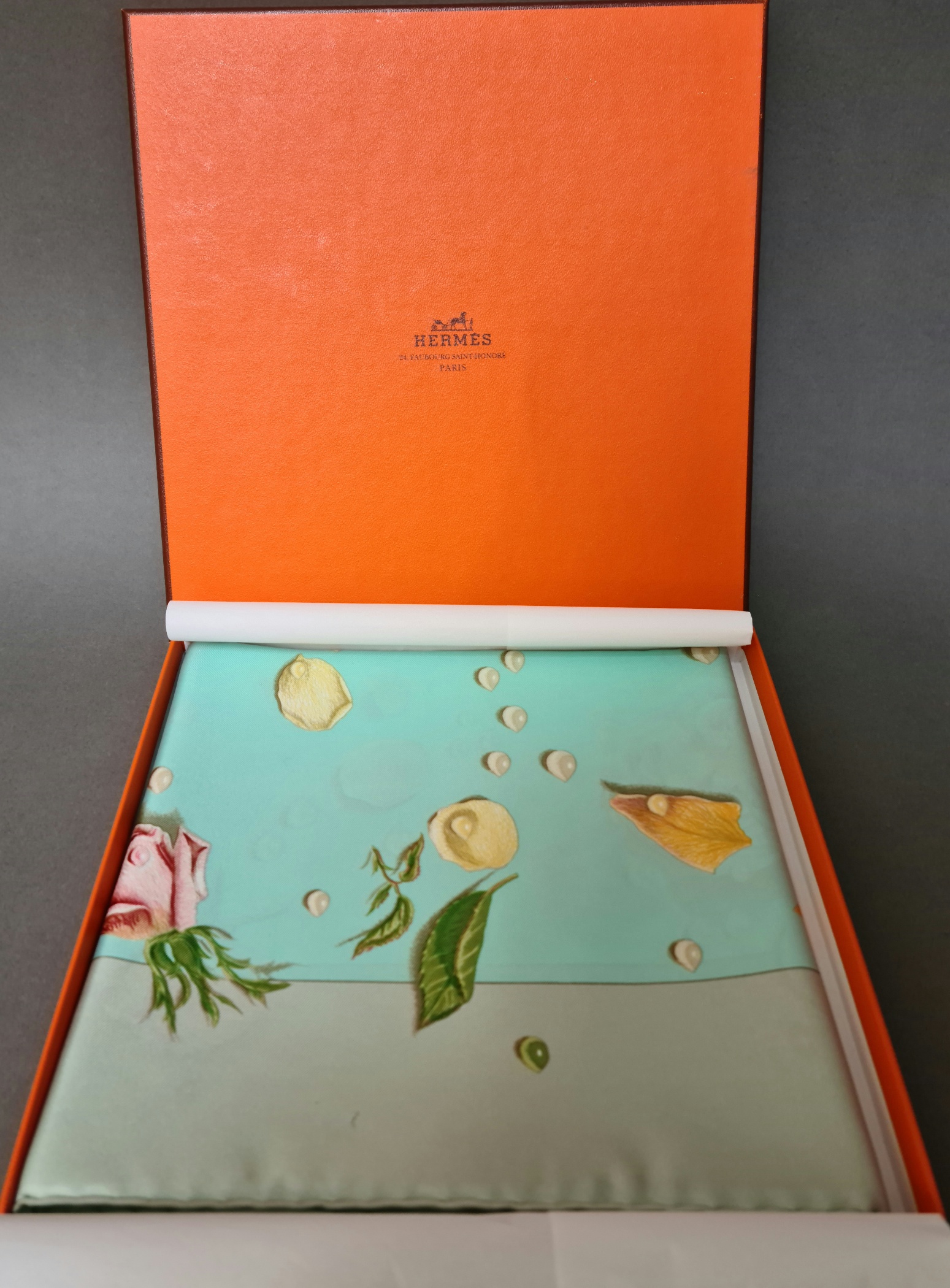 A Hermes "Roses" silk scarf, having various coloured roses on a light blue background, label