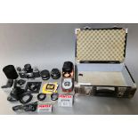 A case of assorted camera equipment comprising a Leitz Extender-R 2x for Leica R, a 2X Kax Macro