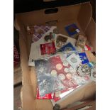 A box of coin sets, including replicas, crowns and medal etc.