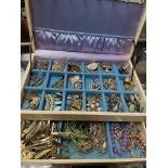 A jewellery box containing a quantity of costume jewellery.