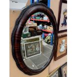 Oval wood framed mirror.