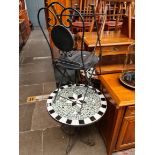 A garden table and 2 metal folding chairs. Diameter 66cm.