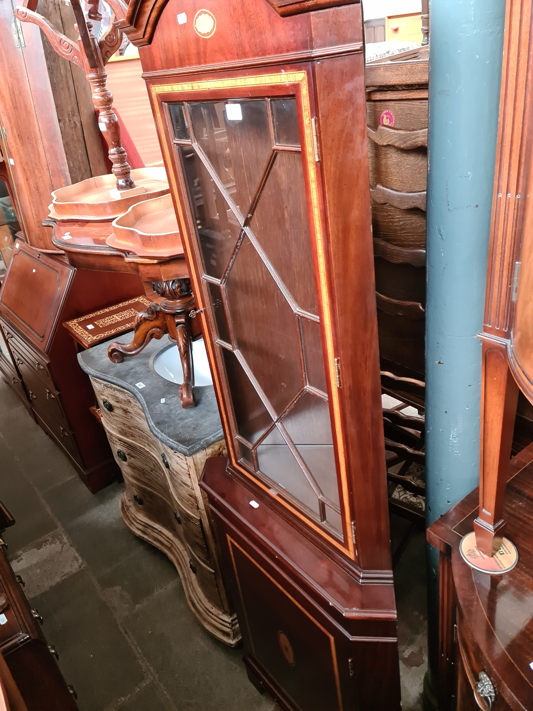 An inlaid mahogany corner cabinet.