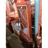 An inlaid mahogany corner cabinet.