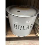 An enamelled circular bread bin with lid.