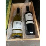 A wooden presentation box containing a bottle of Chile cabernet sauvignon and a bottle of Chile
