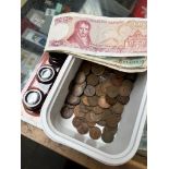 A small tub of mainly farthings, various banknotes and a packet of magnifying loops