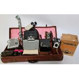 A vintage suitcase with various cameras, binoculars and accessories to include a Chinon facel II,