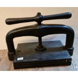 A cast iron book press.