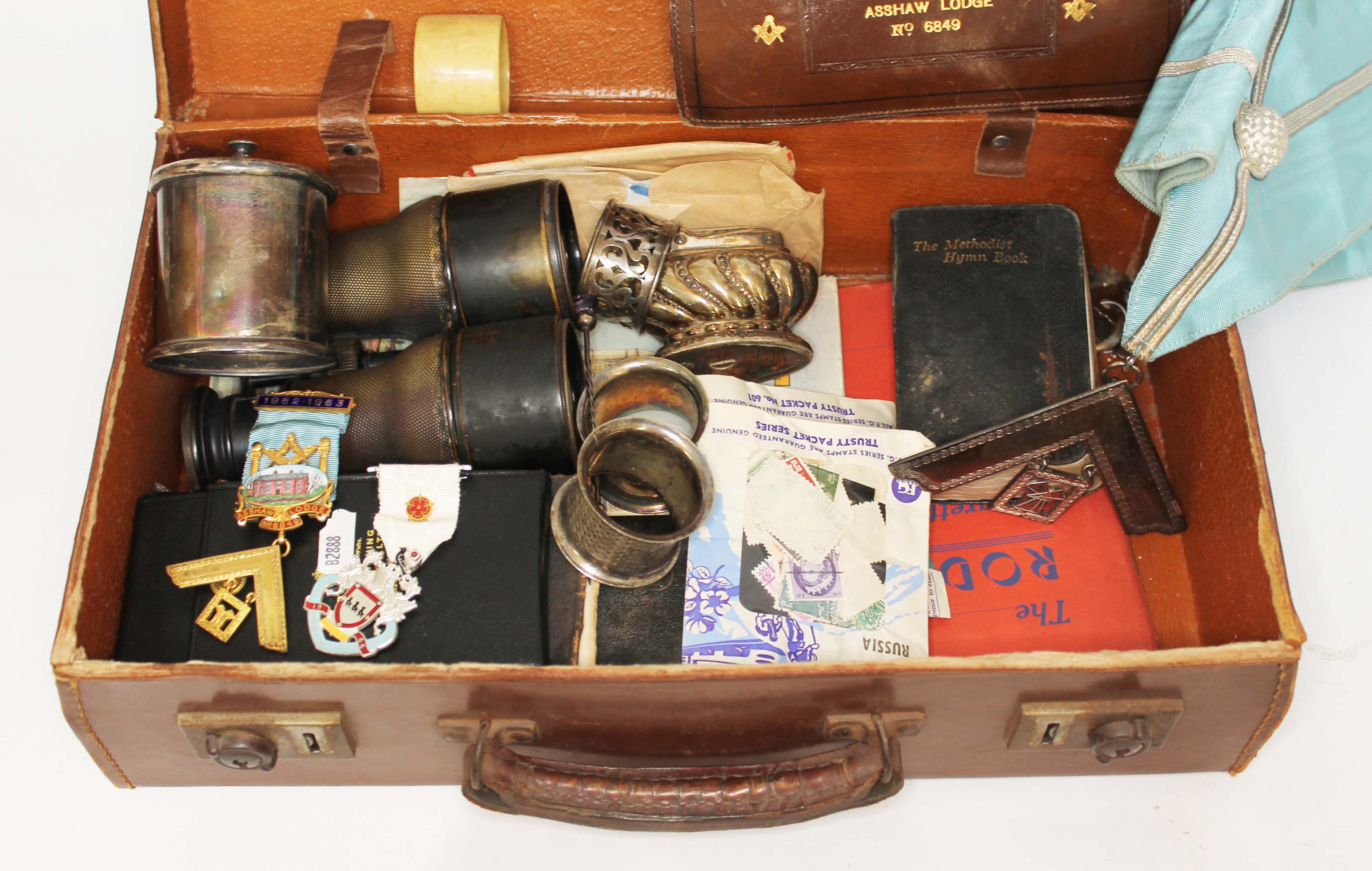 A case of mainly Masonic regalia including a hallmarked silver gilt and enamel jewel, another