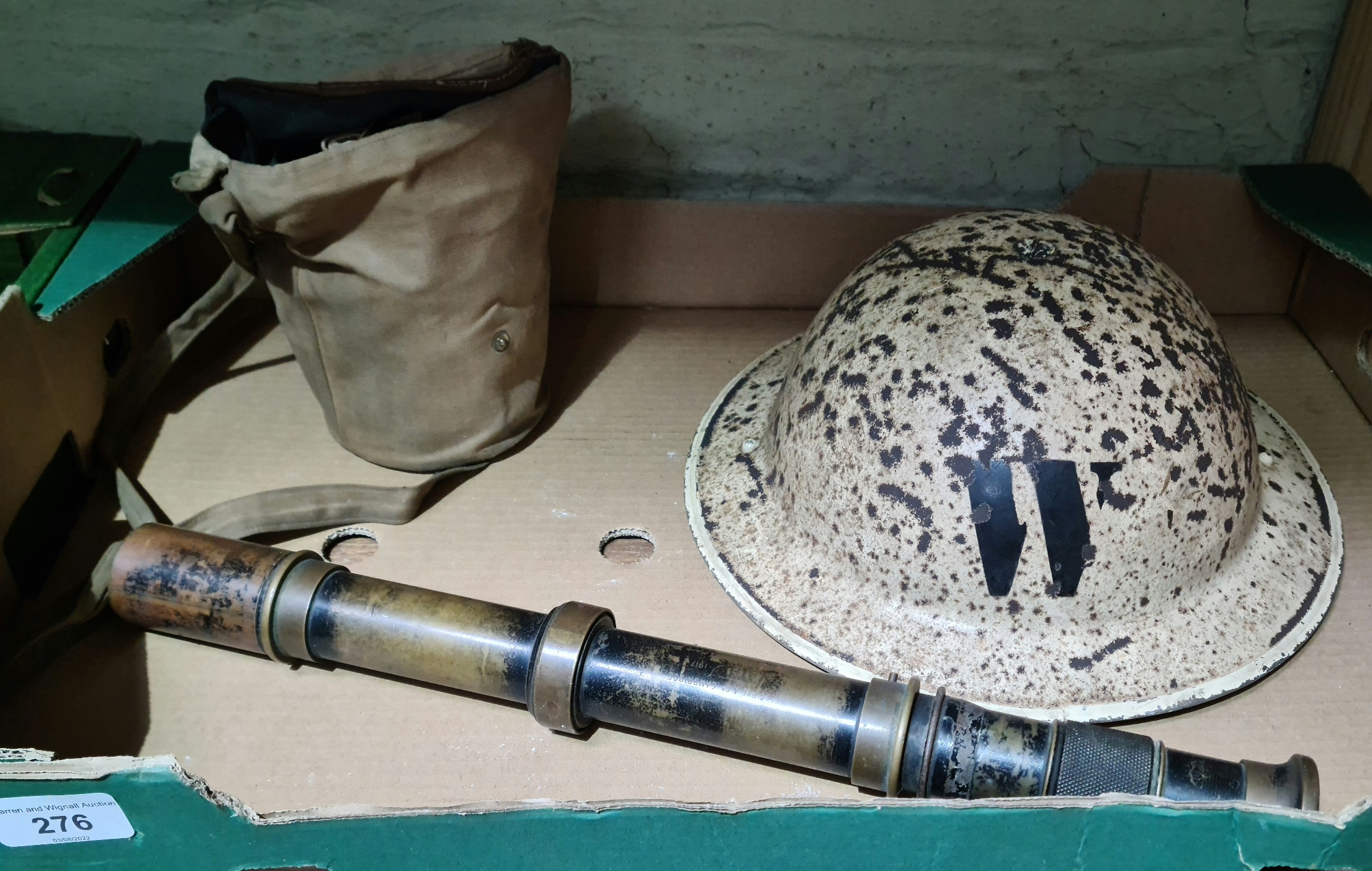 A military helmet, gas mask and telescope.