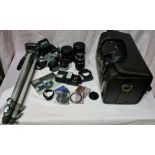 A Canon AE-1 SLR camera with a wide angle lense, telescopic lense, case and a tripod.