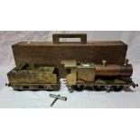 A scratch built 0 gauge live steam engine with tender and wooden case.