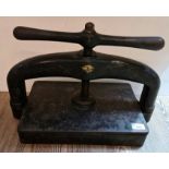 A cast iron book press.